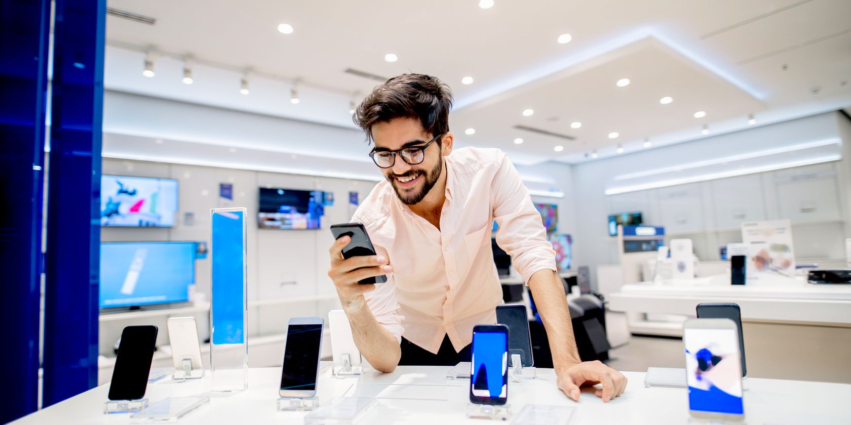 man checking out smartphone specs in store feature