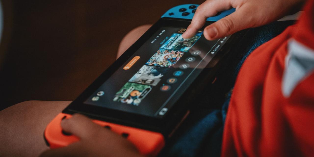 Close up of someone playing the Nintendo Switch in handheld mode