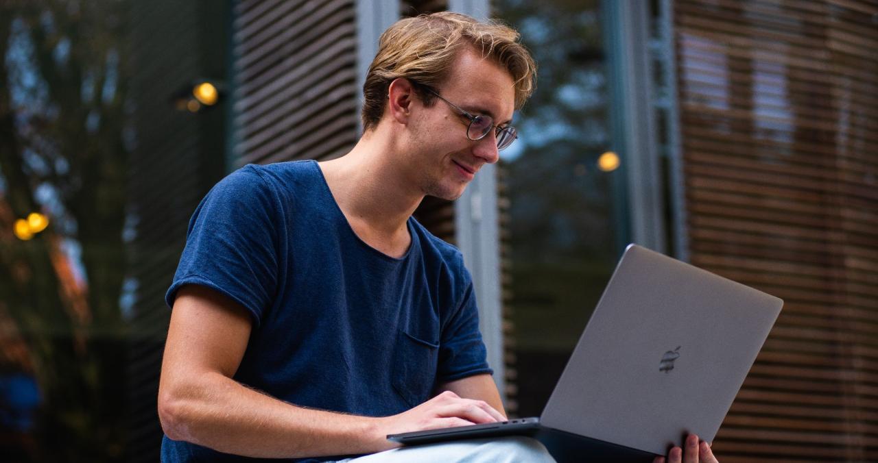 man using laptop outside