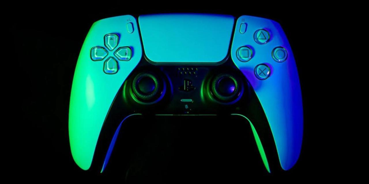 Close up of a PlayStation 5 DualSense controller lit by blue and green lighting