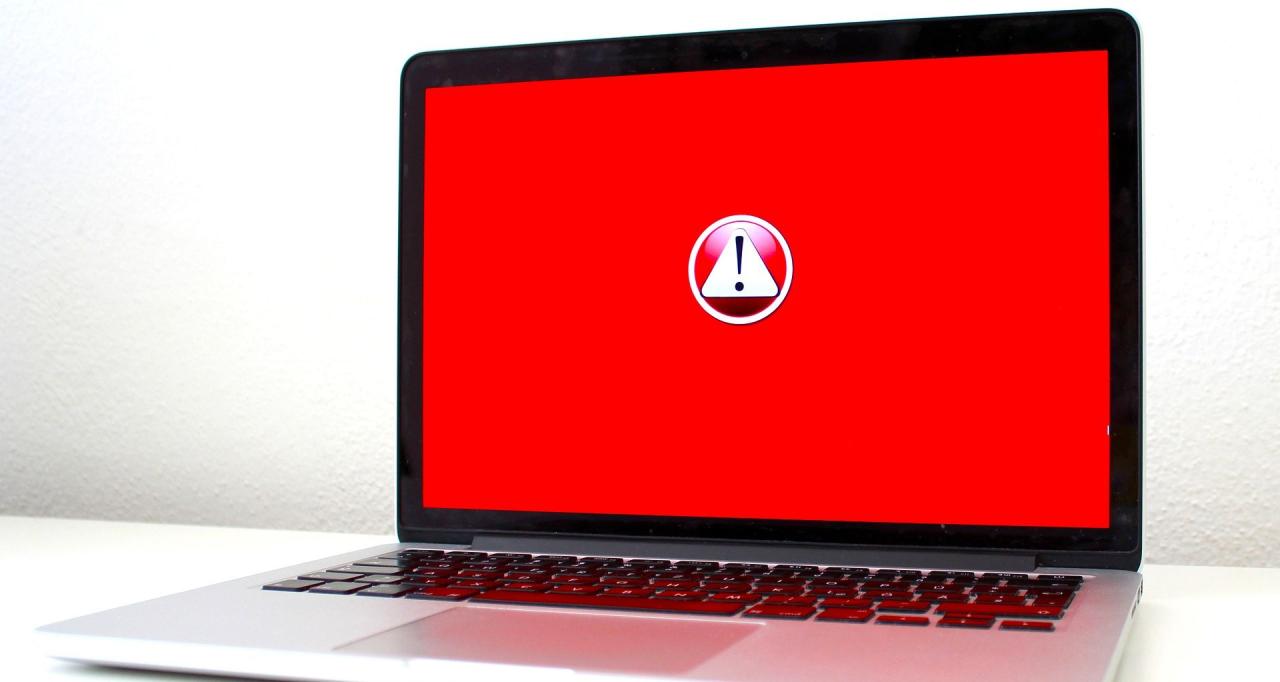 laptop with red alert logo on screen 