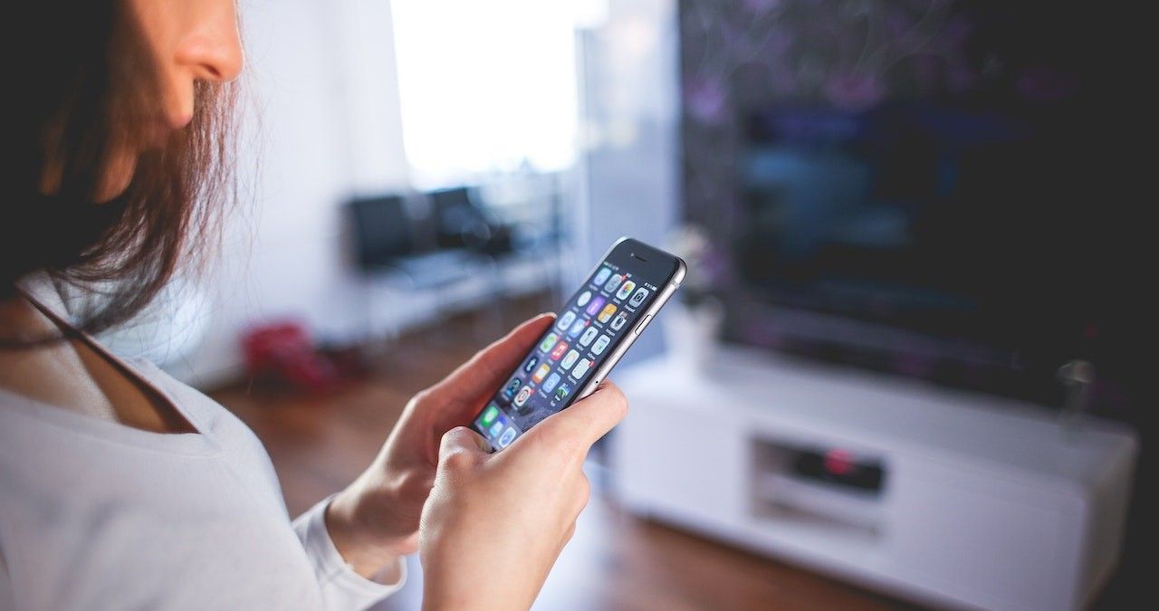 Woman Wearing White V Neck Shirt Using Space Gray Iphone 6