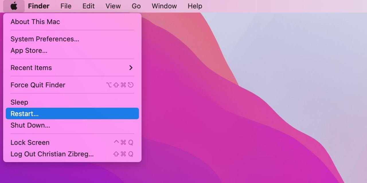 The default macOS Monterey desktop, with the Restart command highlighted in the Finder\'s Apple menu