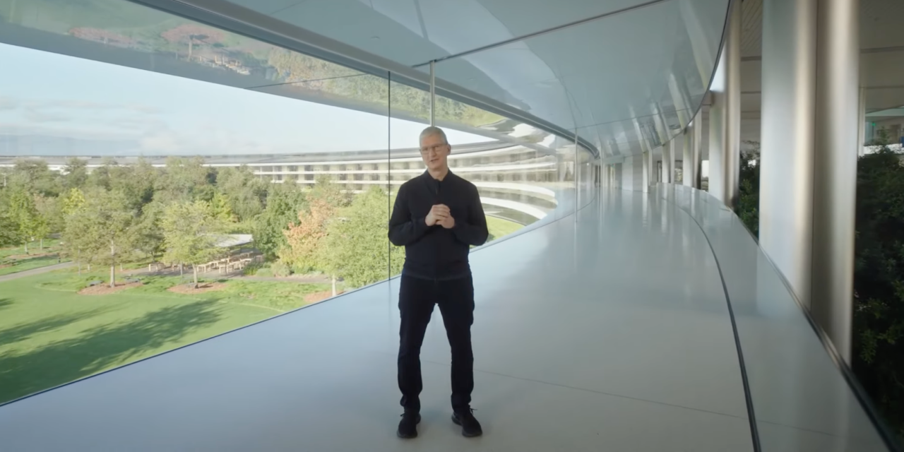 A still from Apple\'s October 2020 keynote video showing CEO Tim Cook in one of the hallways of the Apple Park headquarters