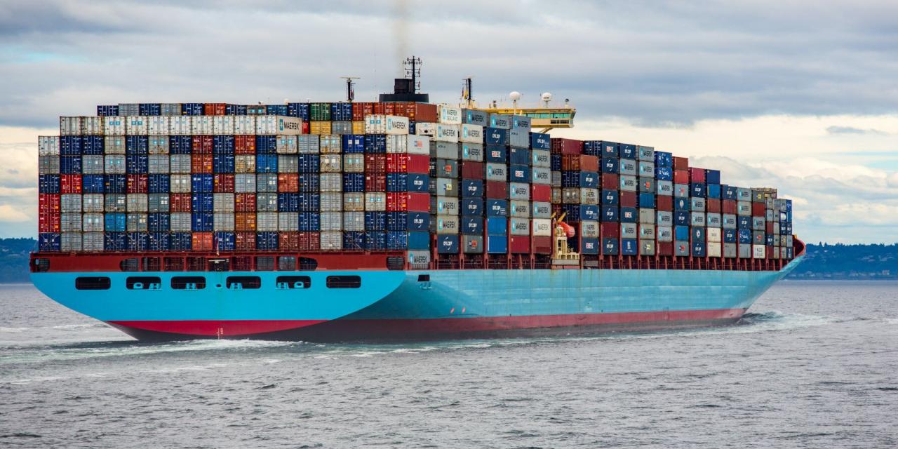 A cargo ship loaded with hundreds of colored shipping containers