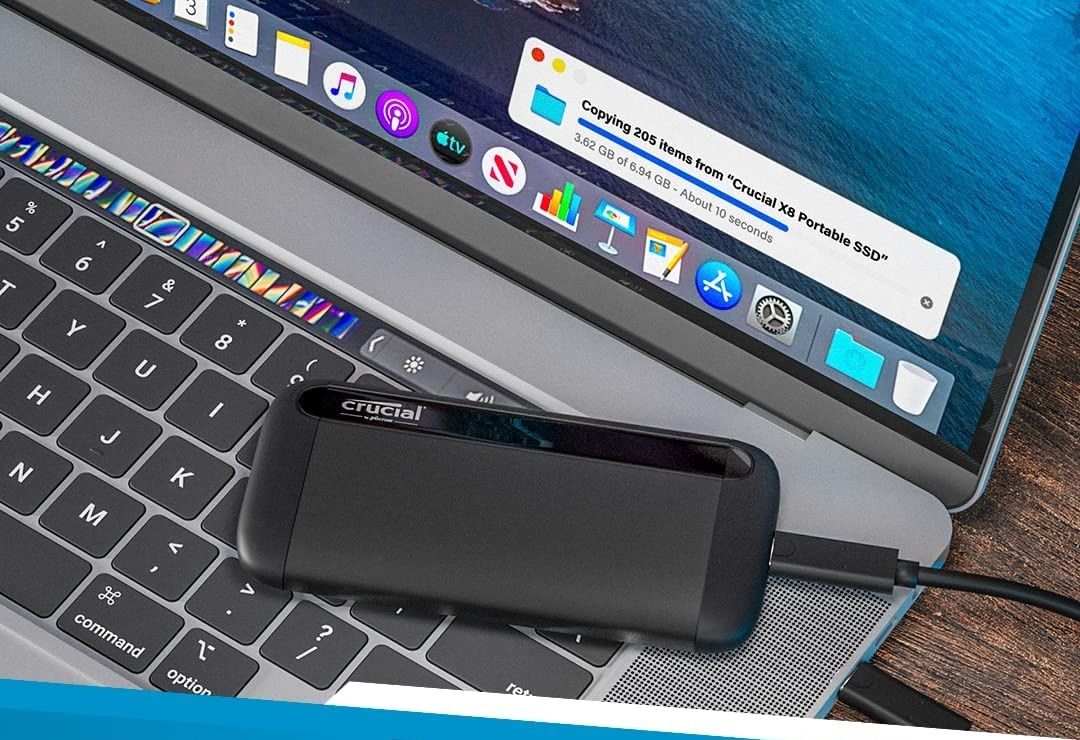 the crucial x8 portable ssd connected to a laptop via usb