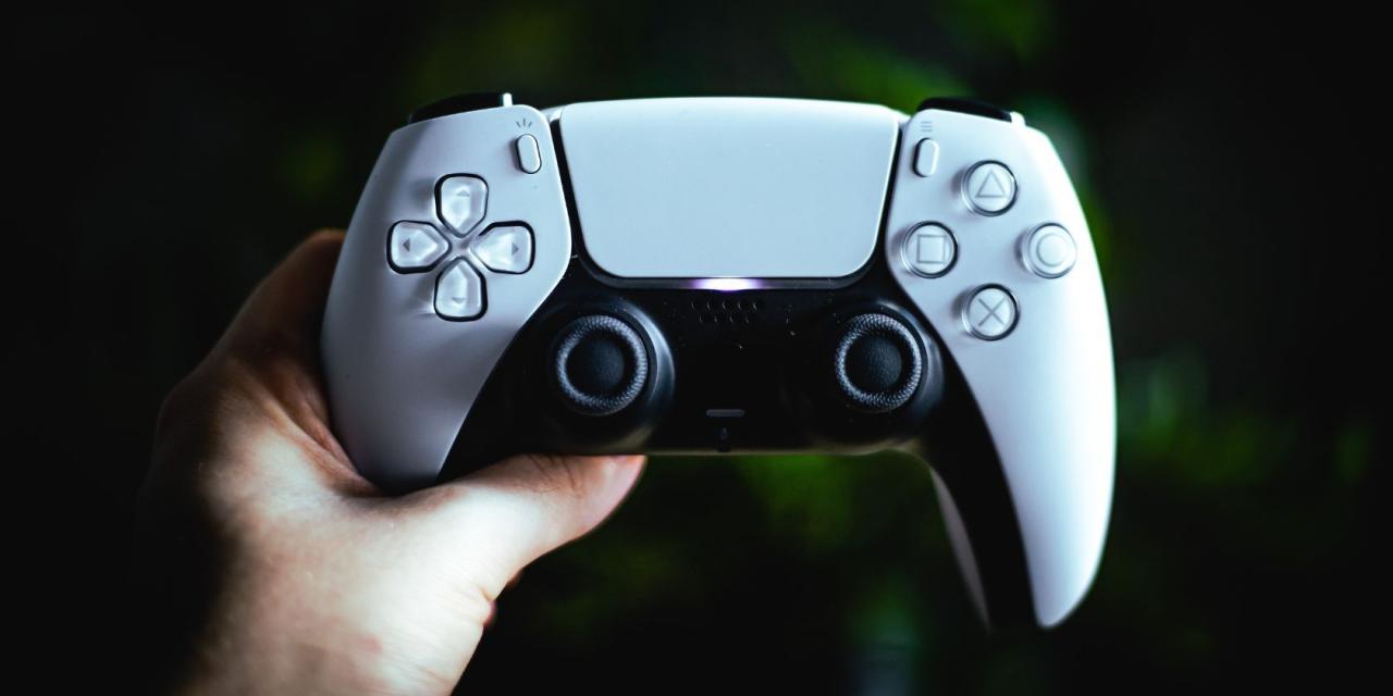 Close up of PS5 DualSense controller in front of green background